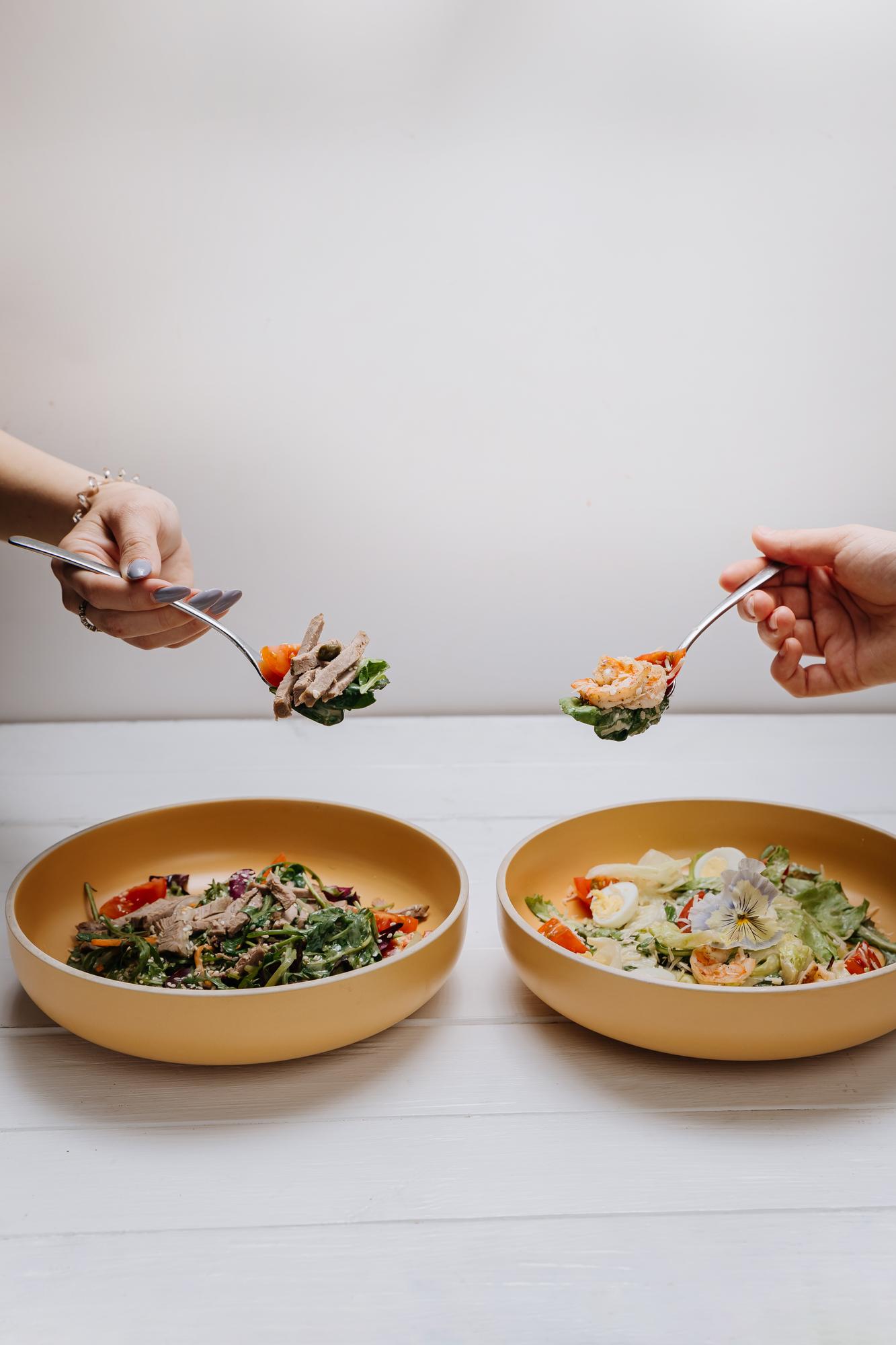 Two cooks sharing a plated meal